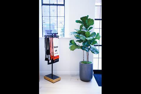 Interior of Peloton store, Covent Garden, London, showing a plant and towels on display